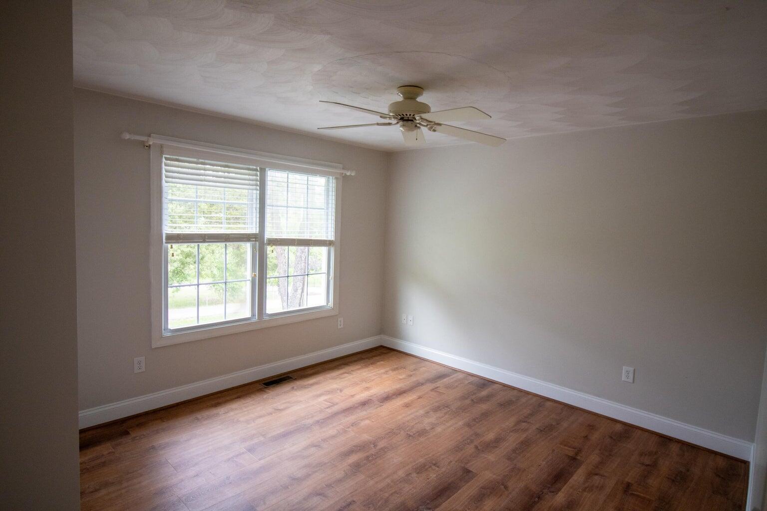 3727 Chaparral Drive Roanoke, VA 24018 - Photo 10 of 24 an empty room with wooden floor ceiling fan and windows