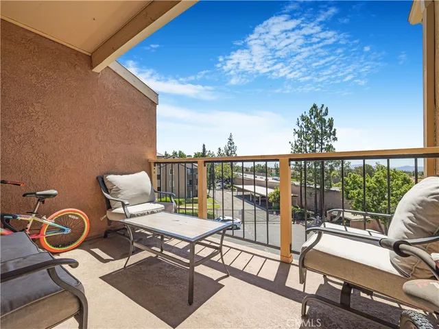 a view of a balcony with chairs