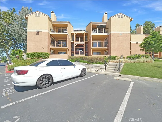 a front view of a residential apartment building with a yard