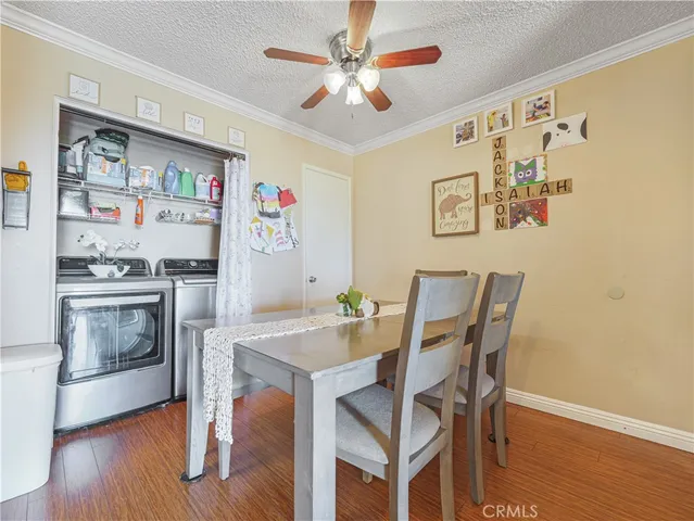 a view of a dining room with furniture and wooden floor