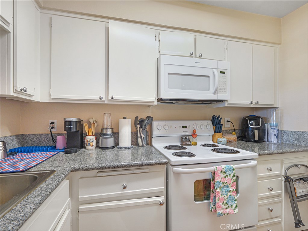 10655 Lemon Avenue, Unit 4009 Rancho Cucamonga, CA 91737 - Photo 6 of 15 a kitchen with granite countertop a sink cabinets and stainless steel appliances
