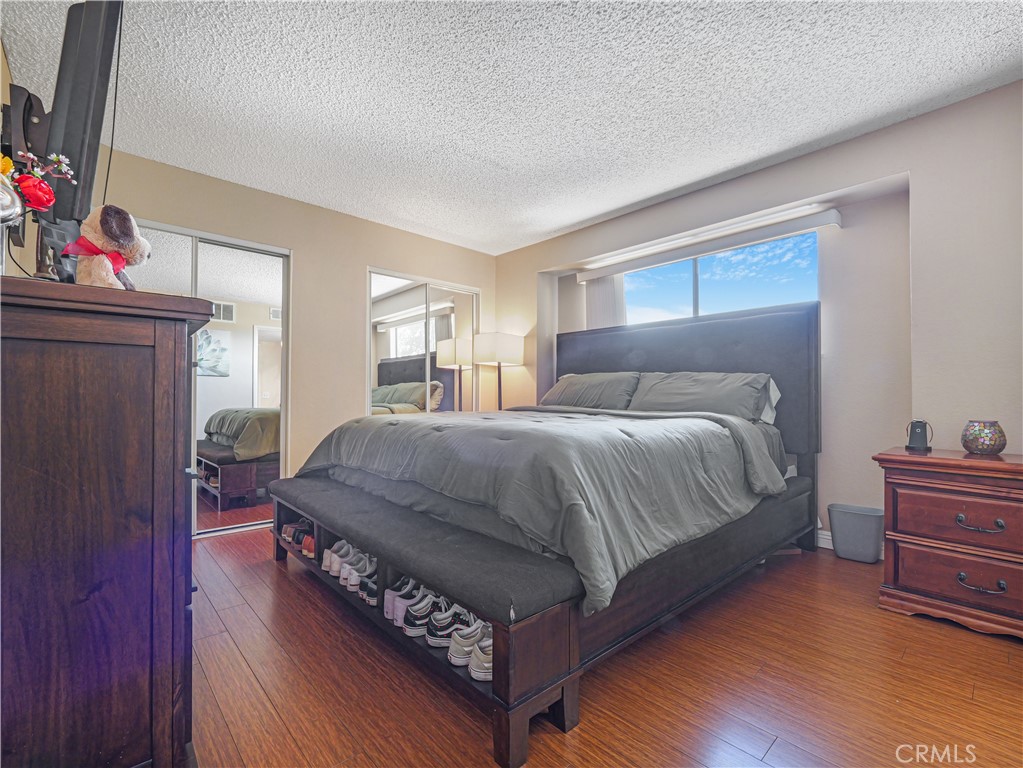 10655 Lemon Avenue, Unit 4009 Rancho Cucamonga, CA 91737 - Photo 8 of 15 a bedroom with a bed and wooden floor