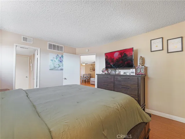 a bed room with a bed and a flat screen tv