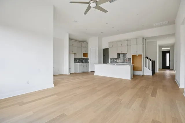 a view of a kitchen with a sink and a refrigerator