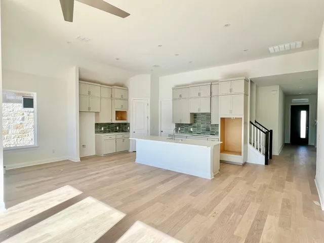 a large kitchen with kitchen island a sink stainless steel appliances and cabinets