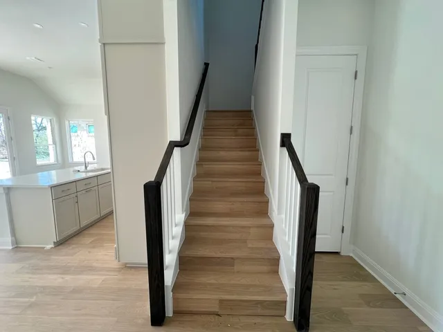 a view of entryway and hall with wooden floor