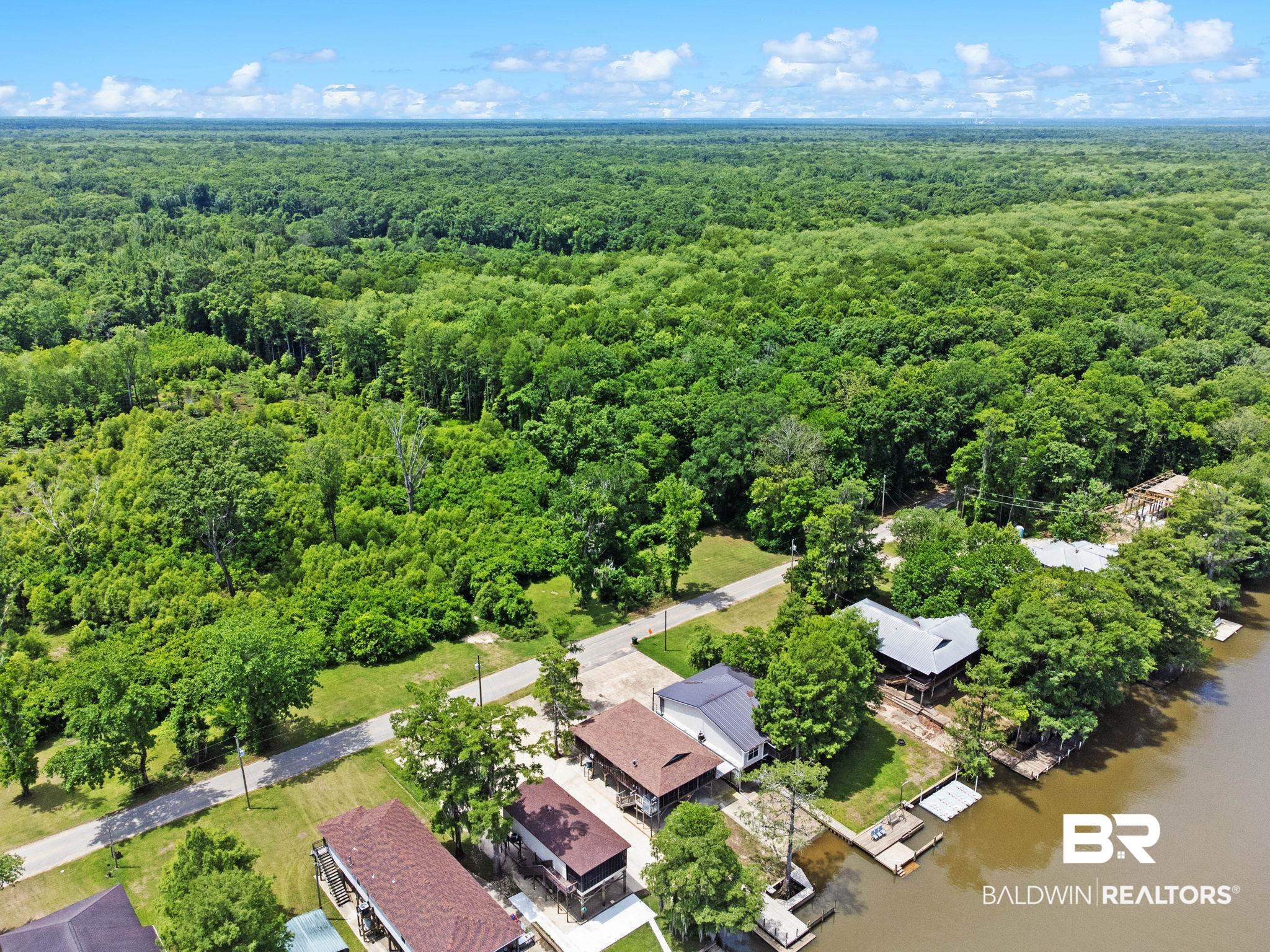 8153 Bryant's Lndg Road Stockton, AL 36579 - Photo 82 of 87 Aerial perspective showcasing expansive wooded areas, waterfront properties, and private boat docks