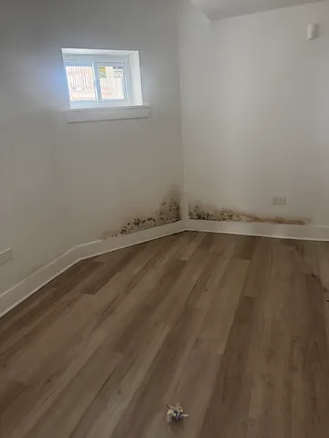 a view of a room with wooden floor and window