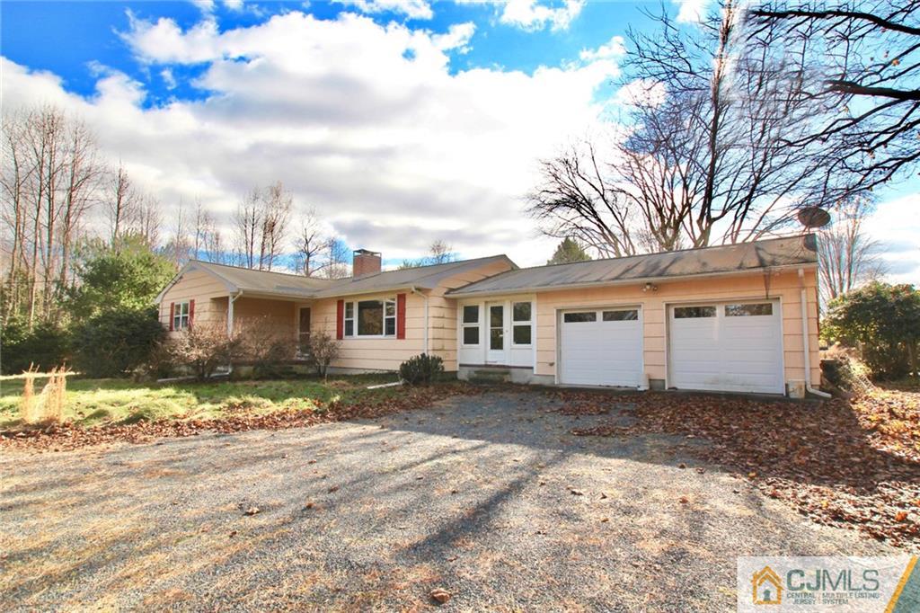 959 Ridge Road Princeton, NJ 08540 - Photo 2 of 25 a front view of a house with a yard covered with trees