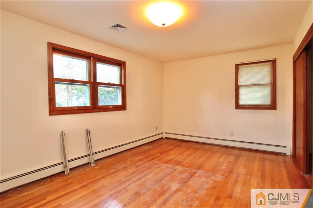 959 Ridge Road Princeton, NJ 08540 - Photo 12 of 25 an empty room with wooden floor and windows