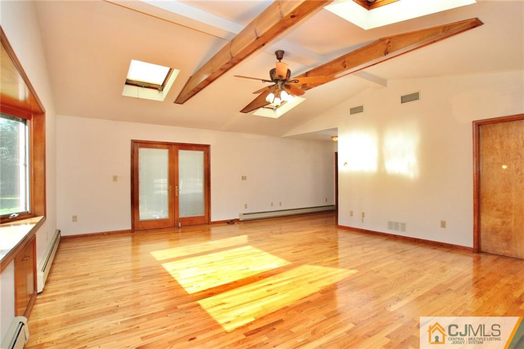 959 Ridge Road Princeton, NJ 08540 - Photo 5 of 25 a view of an empty room with window and wooden floor