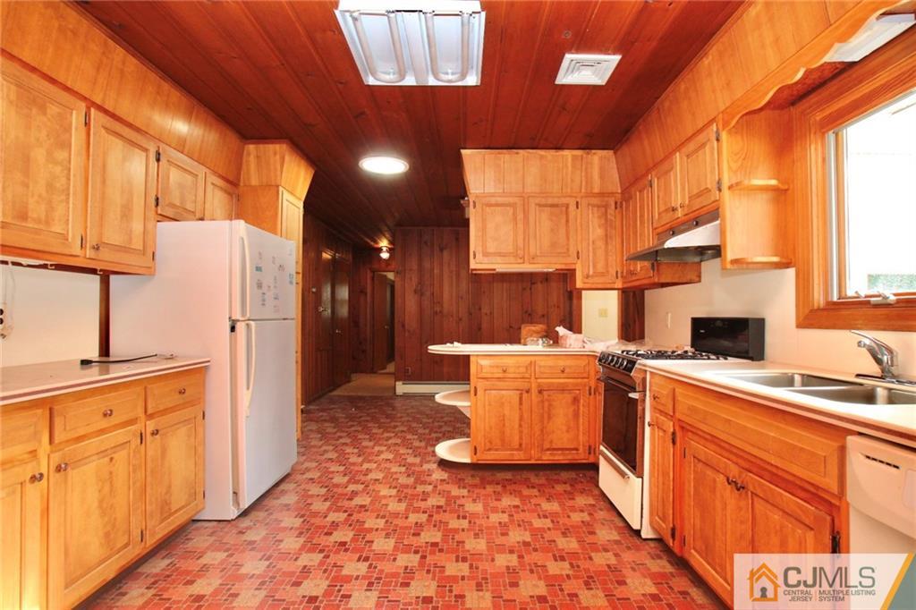 959 Ridge Road Princeton, NJ 08540 - Photo 7 of 25 a kitchen with a sink stove and cabinets