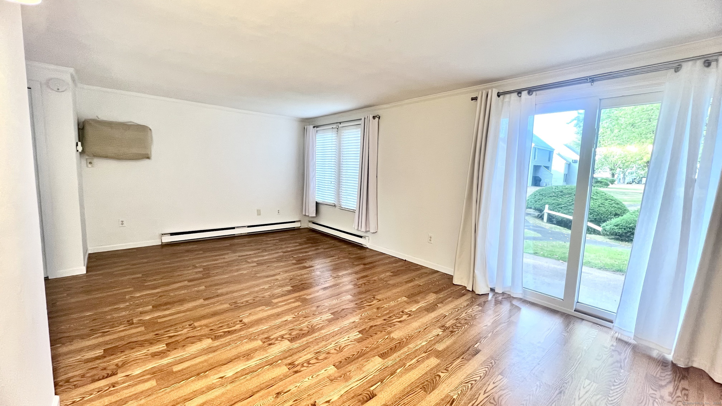 1 Cinnamon Spring, Unit 1 South Windsor, CT 06074 - Photo 4 of 16 a view of an empty room with wooden floor and a window