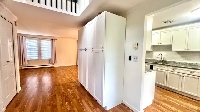 a view of a kitchen cabinets and wooden floor