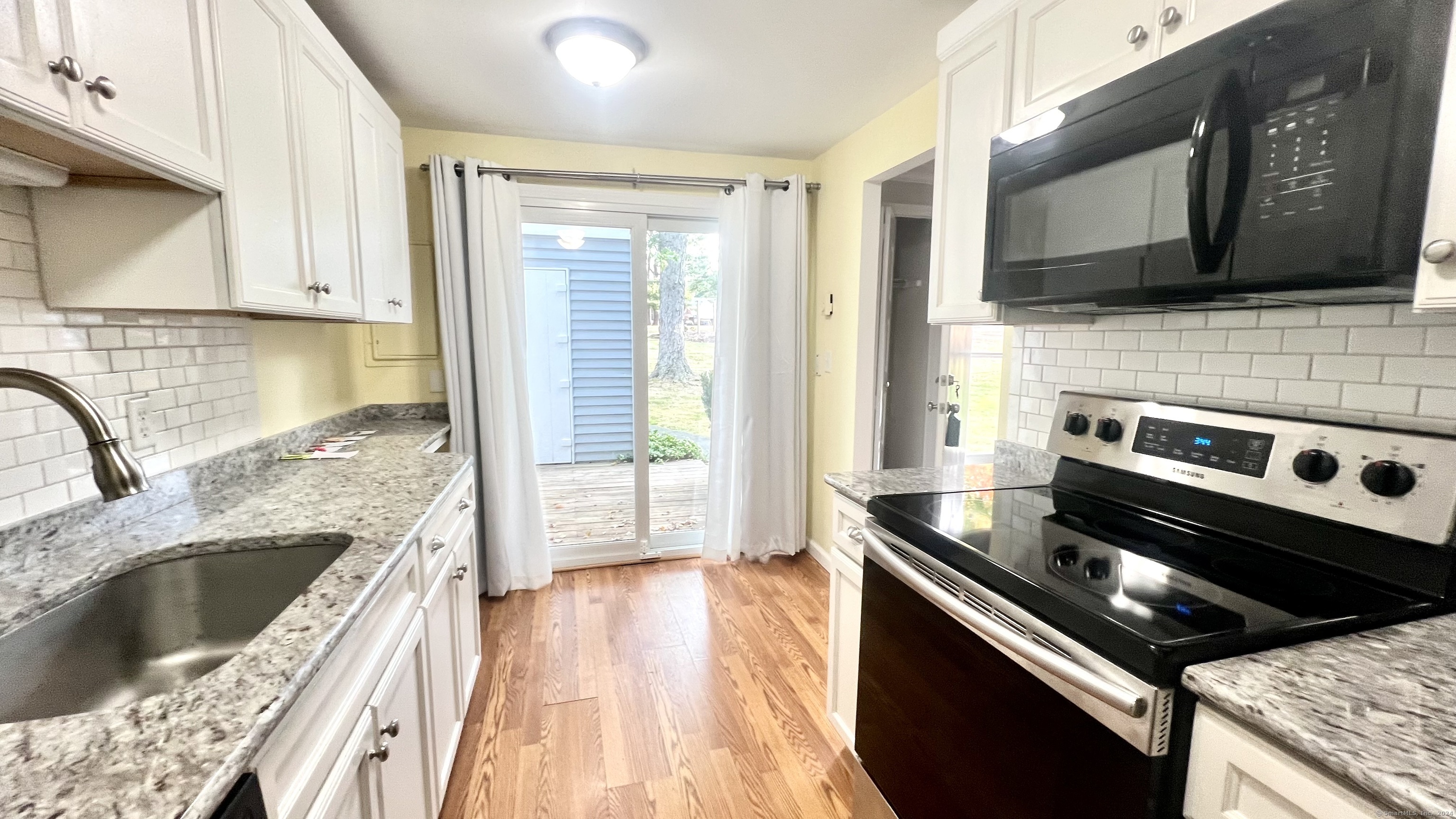 1 Cinnamon Spring, Unit 1 South Windsor, CT 06074 - Photo 7 of 16 a kitchen with a stove a sink and a microwave