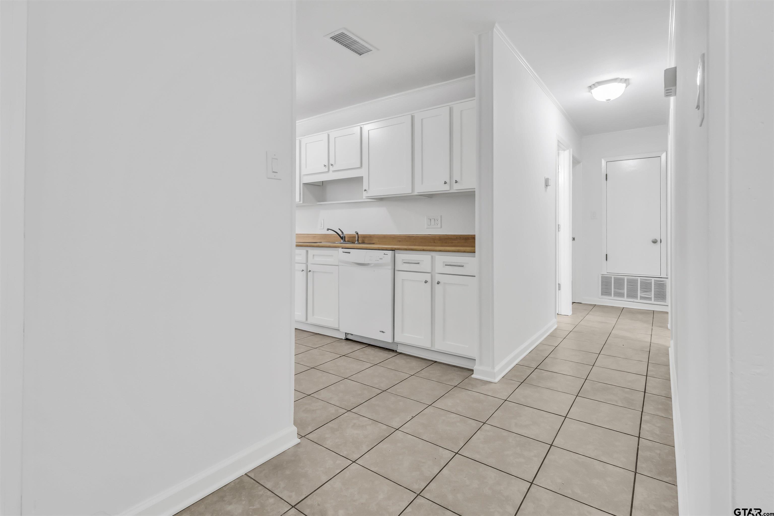 120 Laura Street Mineola, TX 75773 - Photo 11 of 27 a view of a kitchen with white cabinets