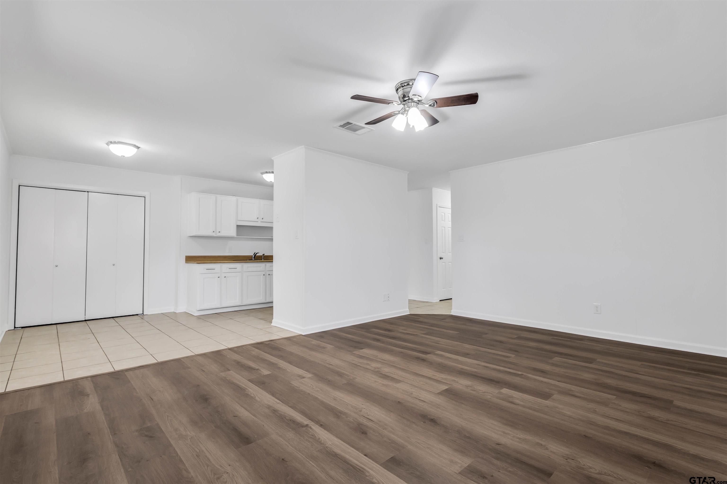120 Laura Street Mineola, TX 75773 - Photo 13 of 27 a view of empty room with wooden floor and window