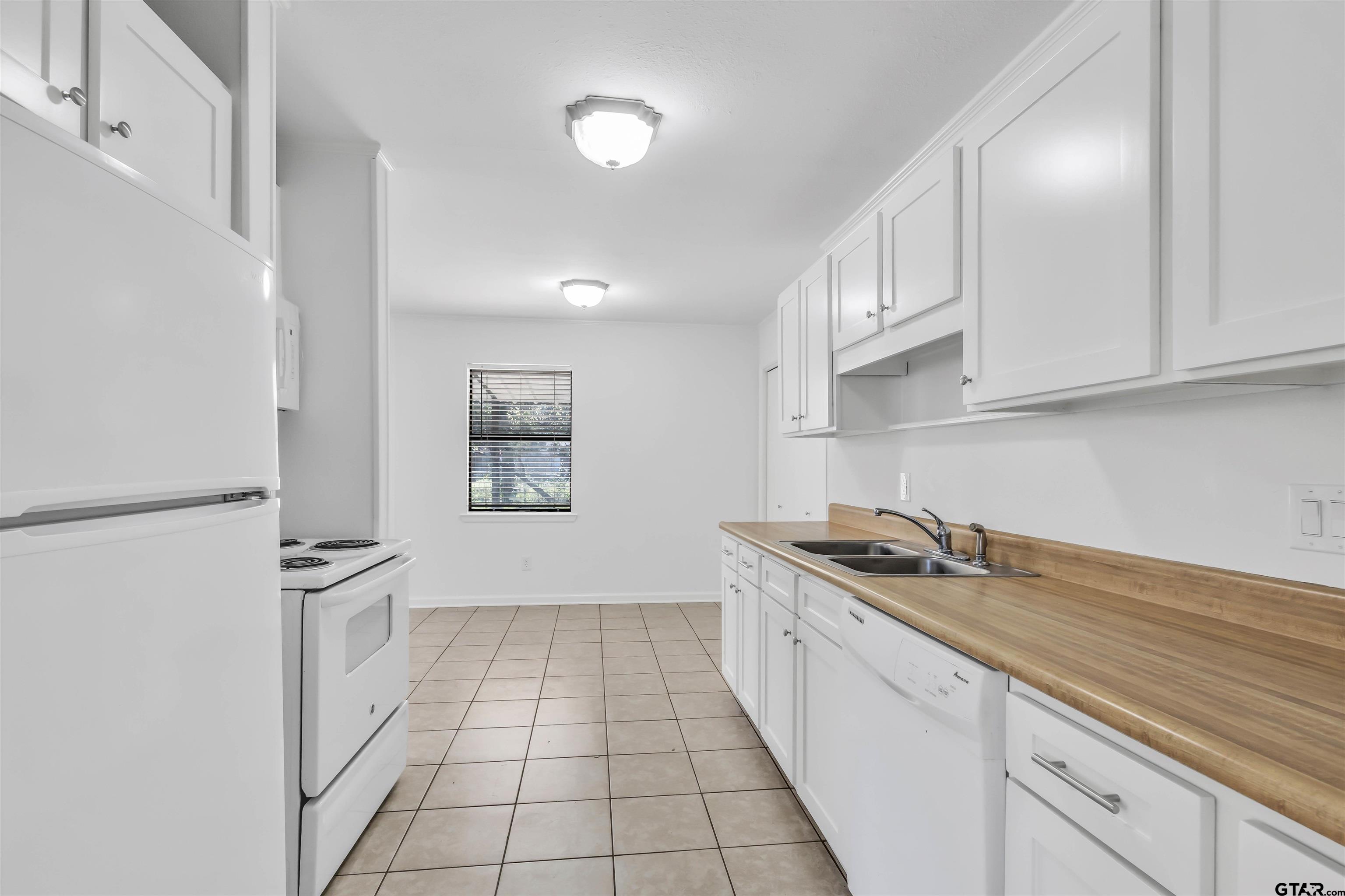 120 Laura Street Mineola, TX 75773 - Photo 17 of 27 a kitchen with stainless steel appliances granite countertop a sink stove and cabinets