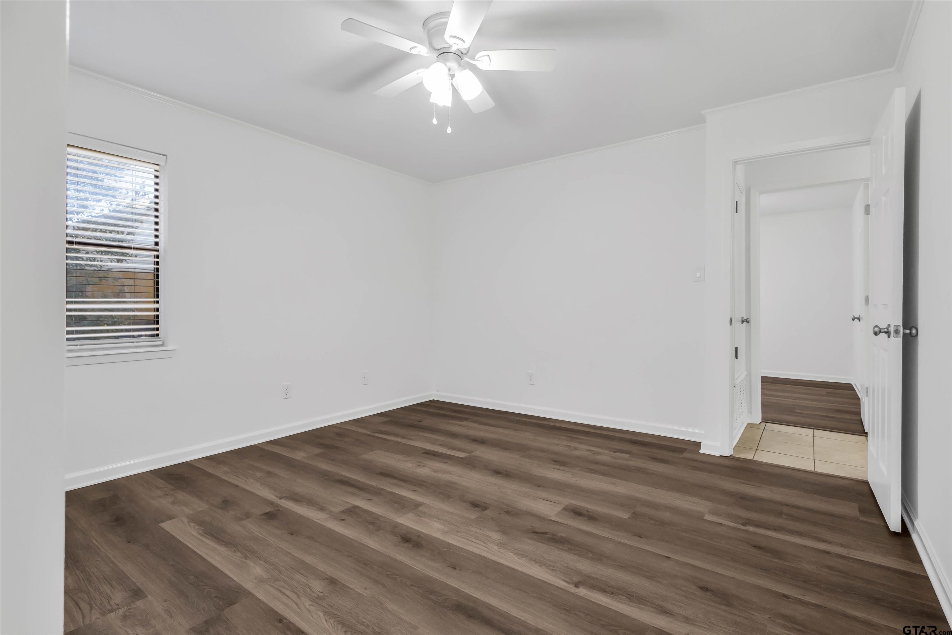 120 Laura Street Mineola, TX 75773 - Photo 19 of 27 a view of empty room with wooden floor and fan