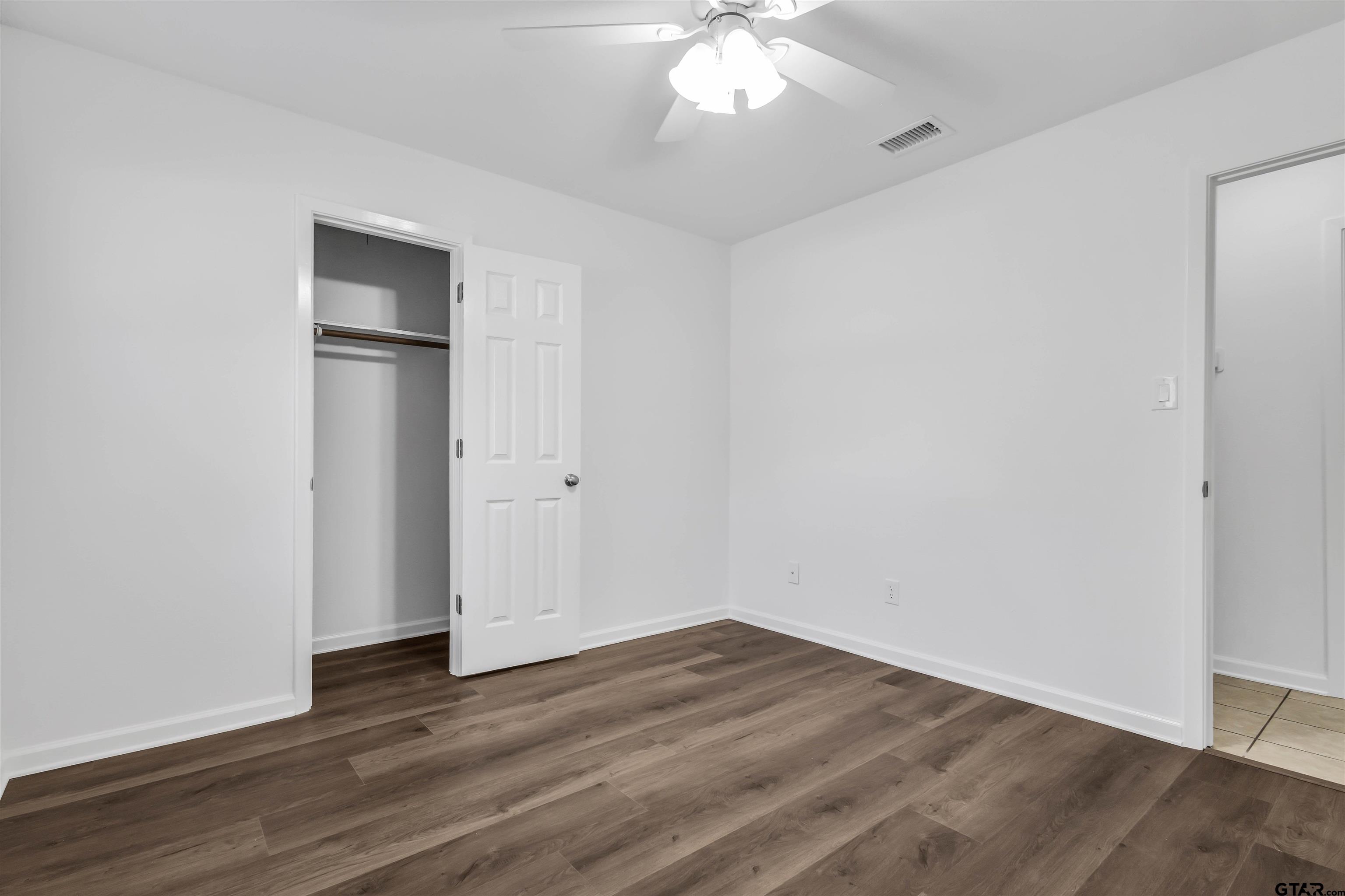 120 Laura Street Mineola, TX 75773 - Photo 22 of 27 a view of an empty room with wooden floor