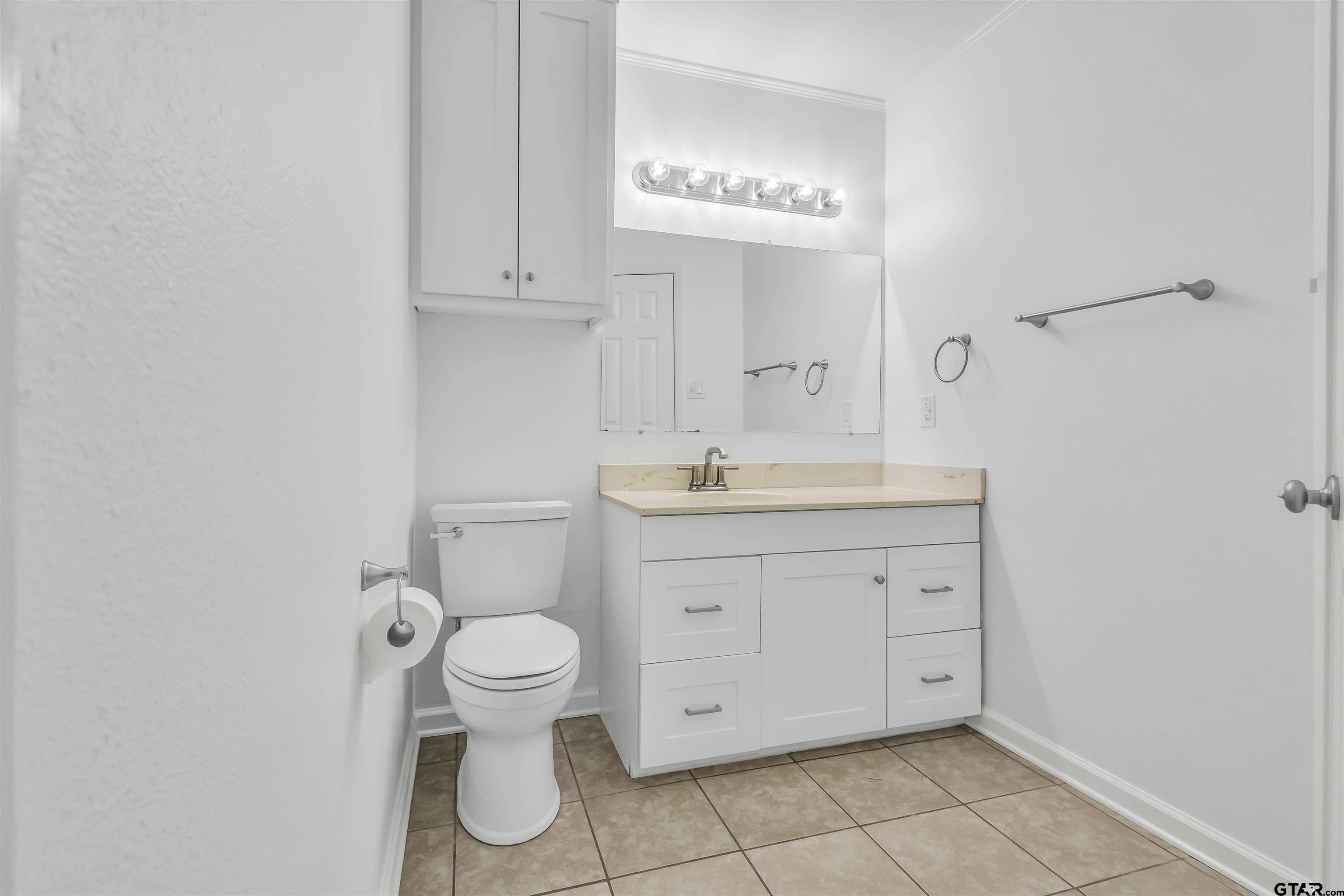 120 Laura Street Mineola, TX 75773 - Photo 24 of 27 a view of bathroom with a toilet sink and a mirror