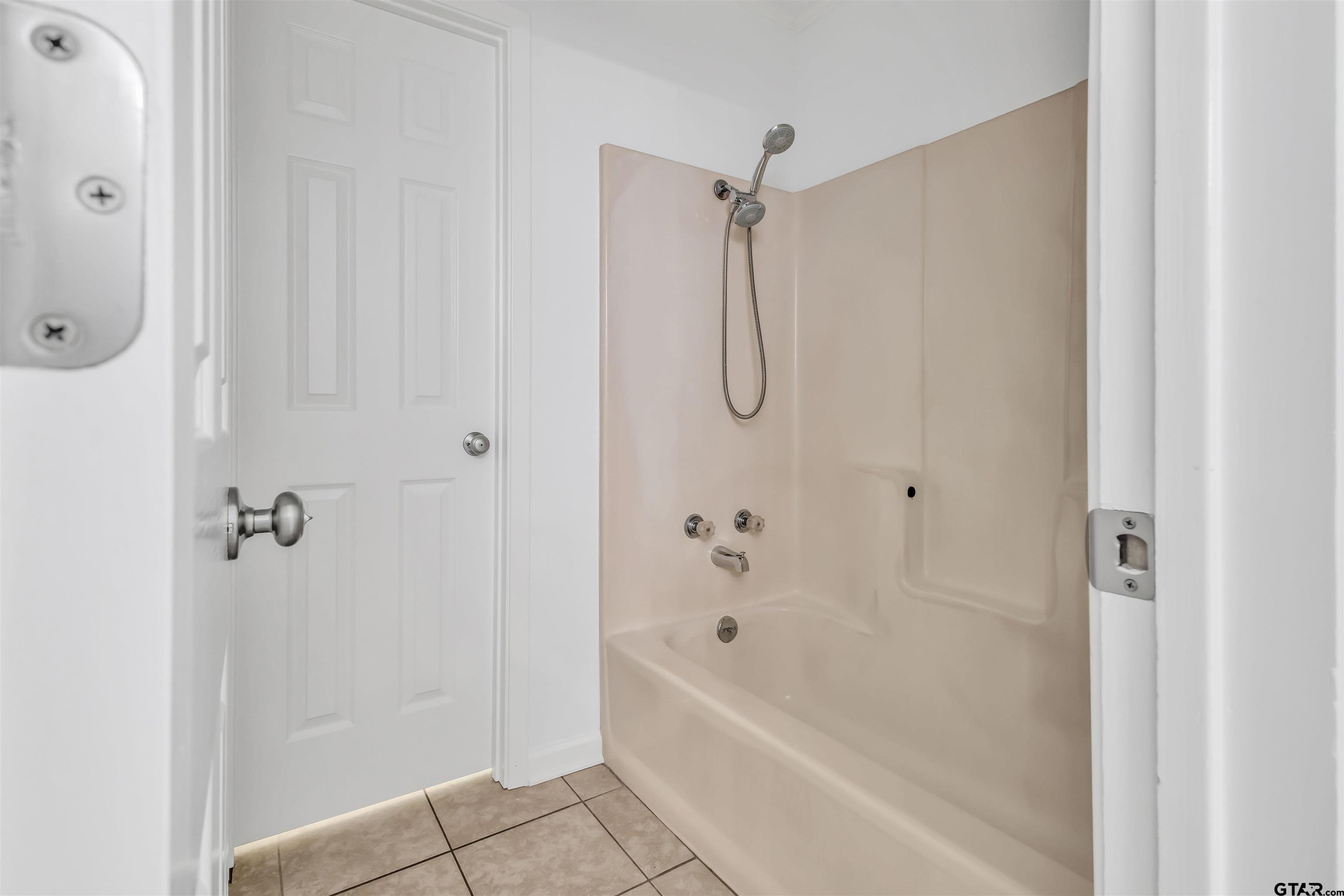 120 Laura Street Mineola, TX 75773 - Photo 26 of 27 a bathroom with a bathtub a shower and a shower