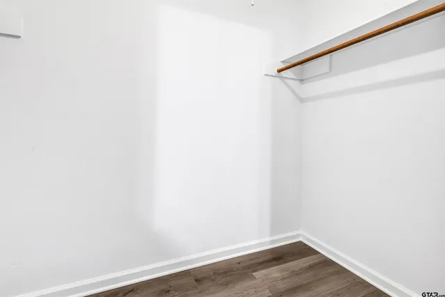 a view of a small space with wooden floor and closet