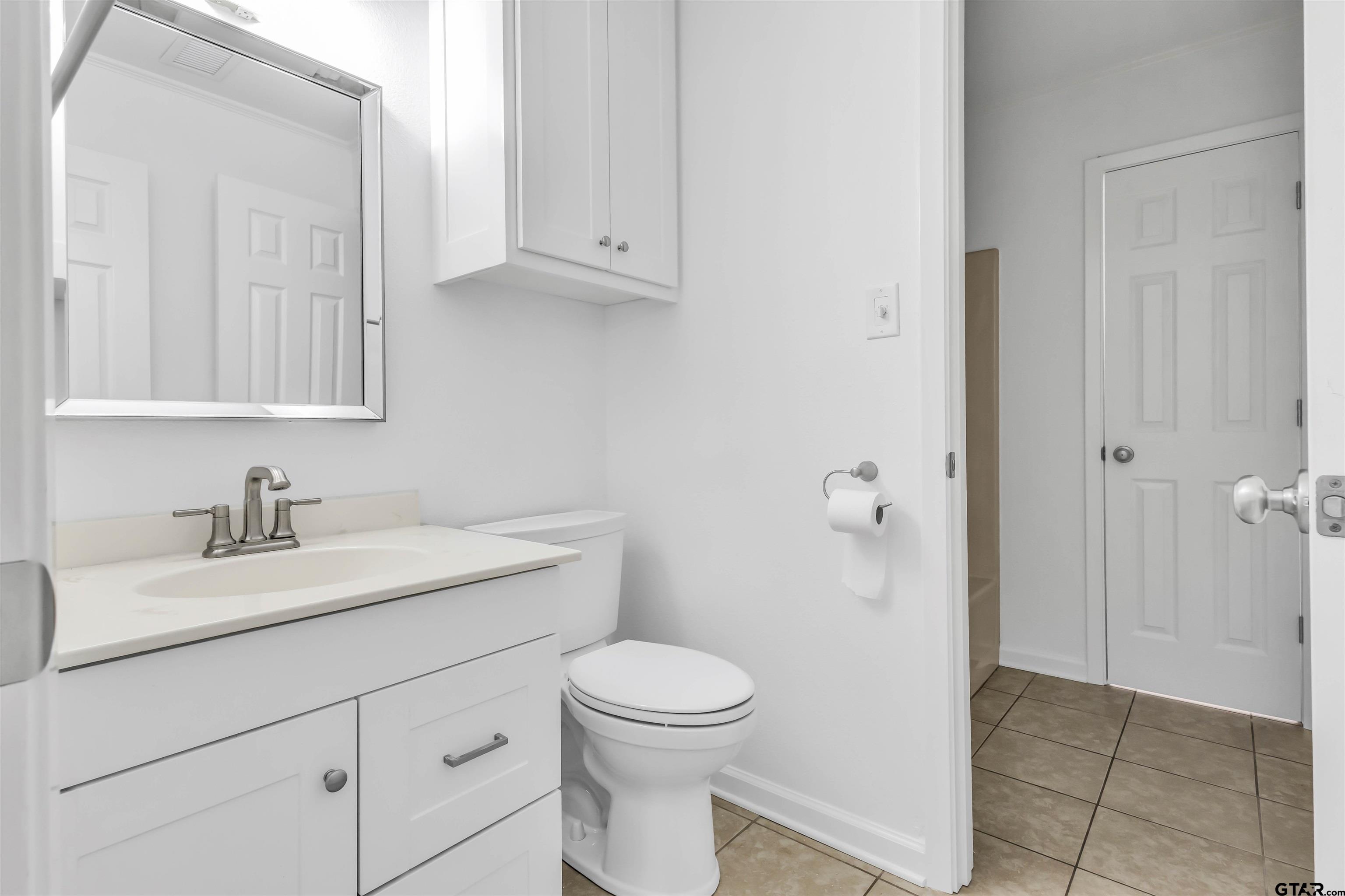 120 Laura Street Mineola, TX 75773 - Photo 27 of 27 a bathroom with a granite countertop sink a toilet and a mirror