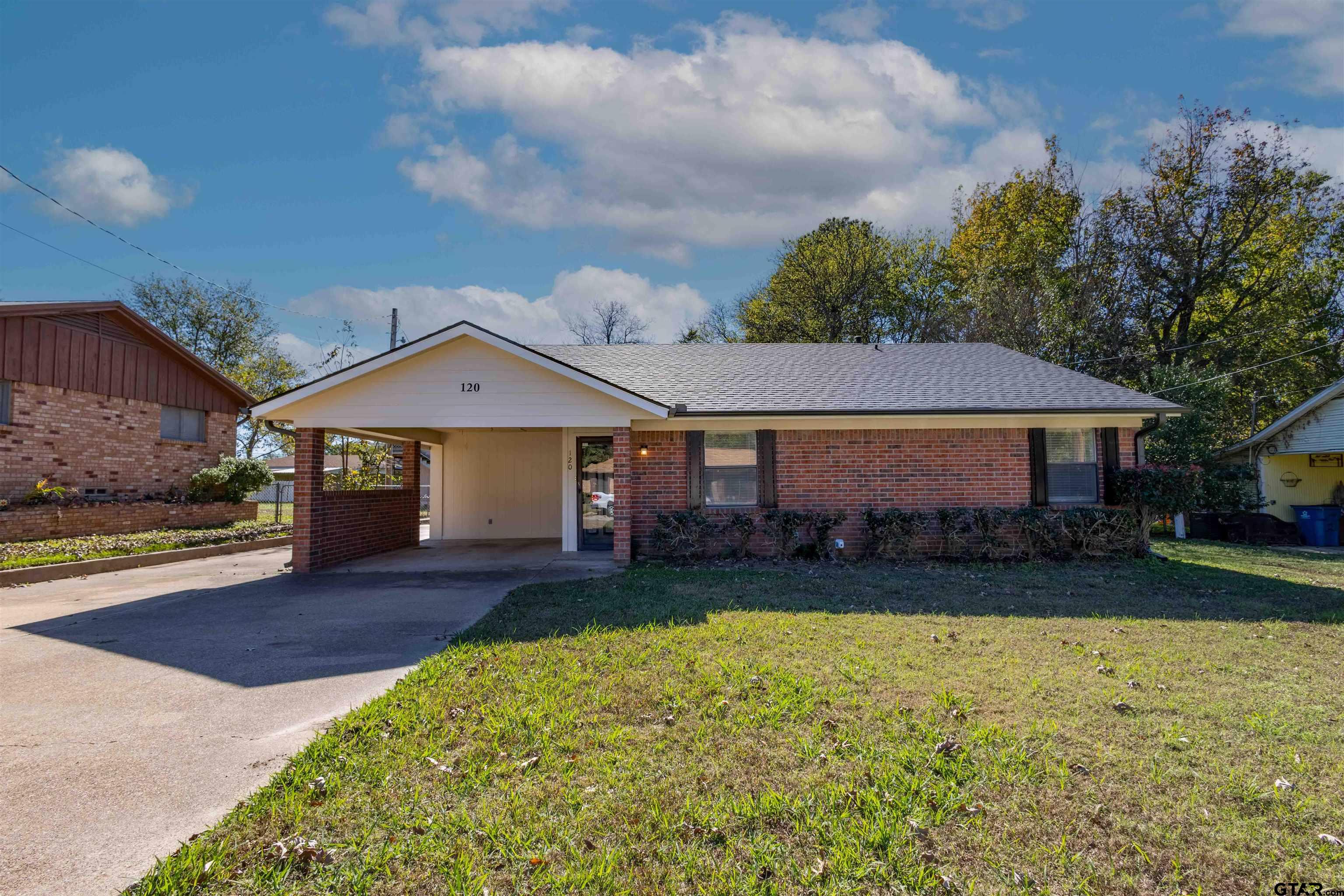 120 Laura Street Mineola, TX 75773 - Photo 4 of 27 a front view of a house with a yard and garage