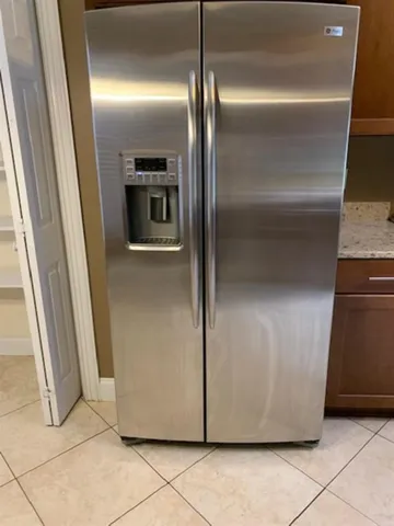 a view of a refrigerator in kitchen and a refrigerator in a kitchen
