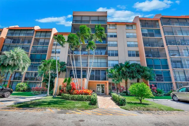a spacious bedroom with a large bed and a chandelier