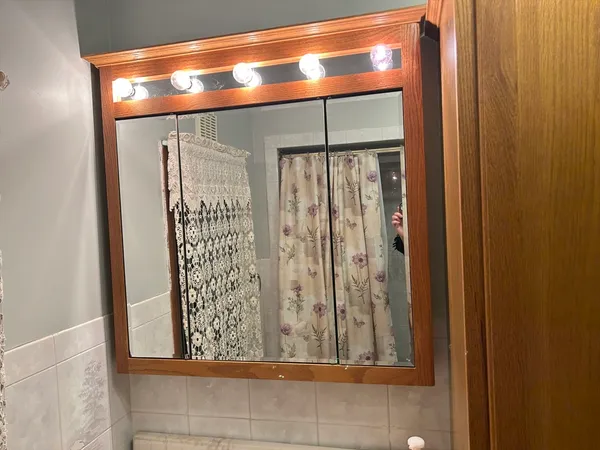 a bathroom with a granite countertop sink and a shower curtain