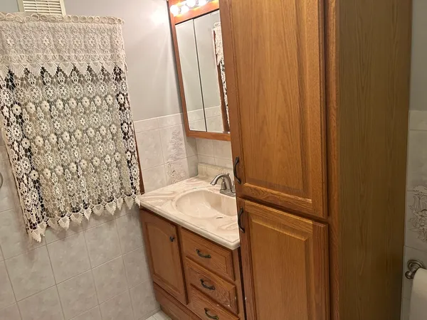a view of a bedroom with window and cabinet