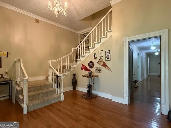 a view of entryway with wooden floor and stairs