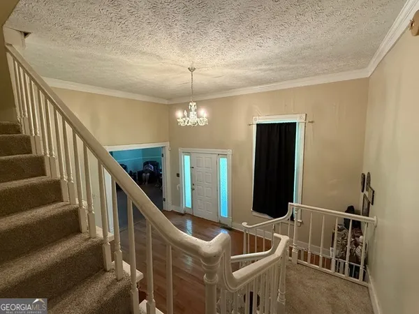 a living room with stairs and furniture