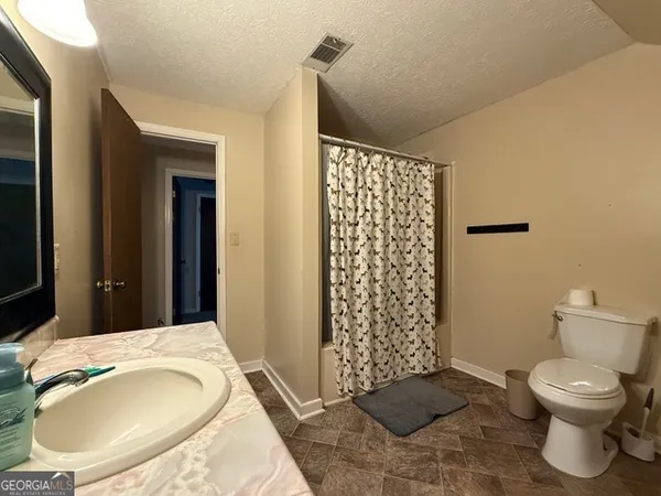 a bathroom with a toilet and a sink