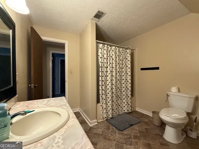 a bathroom with a toilet and a sink