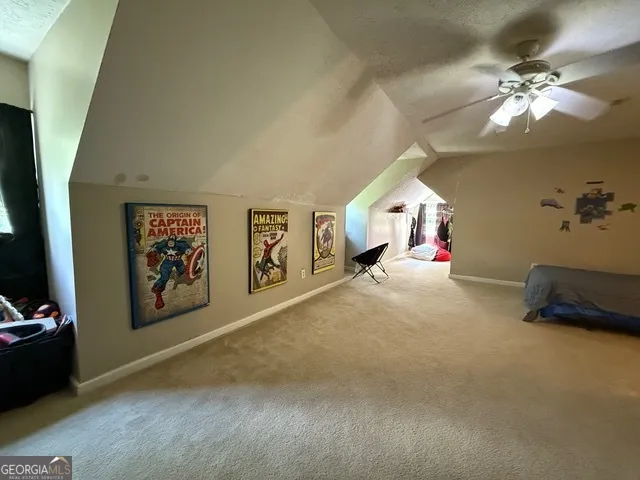 a living room with furniture and a mirror