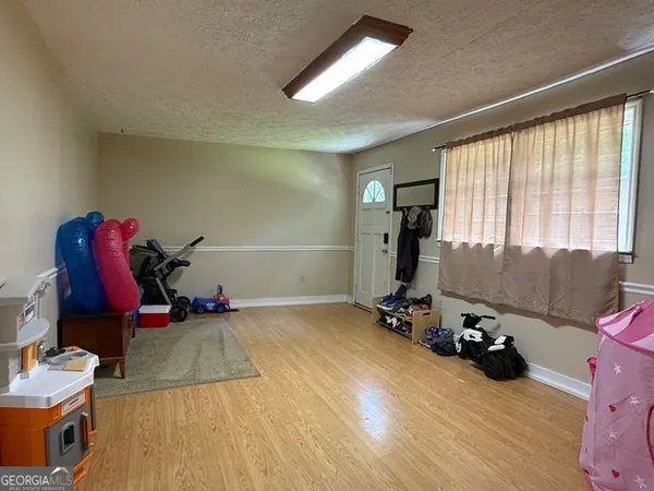 a view of a room with gym equipment and a large window