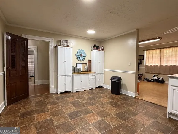 a view of a refrigerator in kitchen and windows