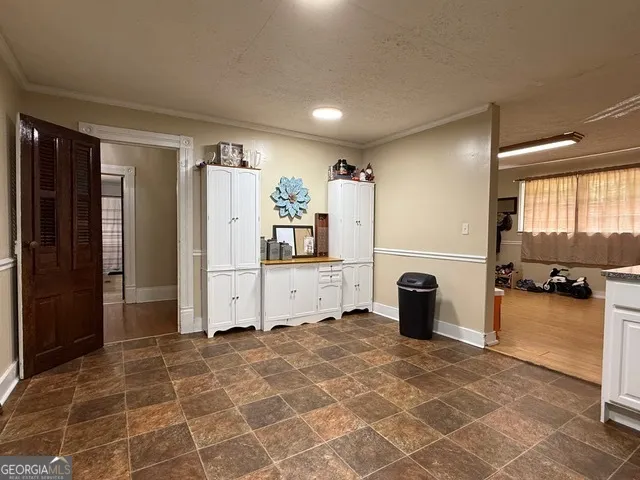 a view of a refrigerator in kitchen and windows