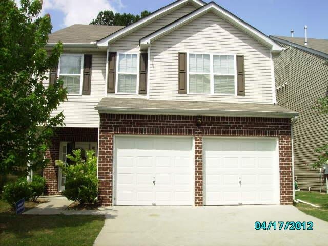 5805 Little River Road, Unit 52 Atlanta, GA 30349 - Photo 1 of 1 a front view of a house with a garden