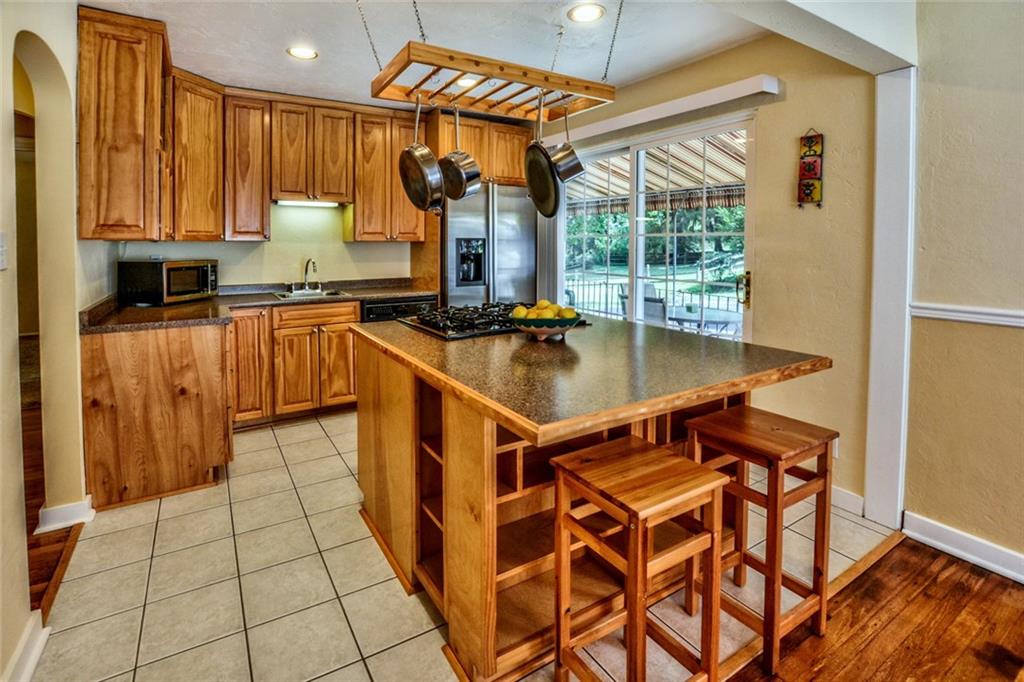 109 Deimling Road Pittsburgh, PA 15229 - Photo 2 of 23 Kitchen - Featuring Large Center Island and Richly Stained Cabinetry. Lots of Natural Light entering through Sliding Doors Leading to Patio/Porch.