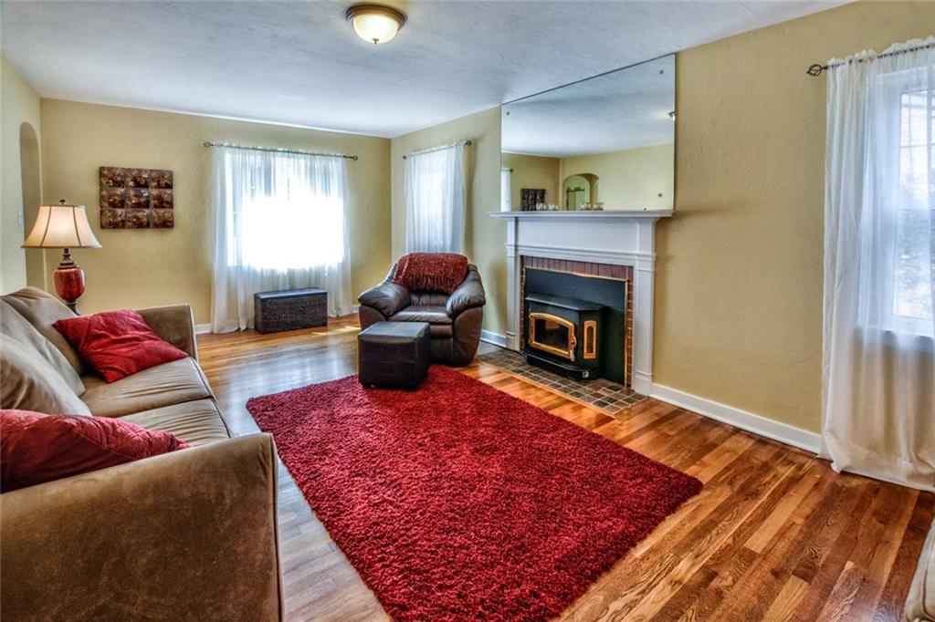 109 Deimling Road Pittsburgh, PA 15229 - Photo 7 of 23 Living Room - Gleaming Hardwood Floors and a Log Burning Fireplace provide a Cozy Retreat