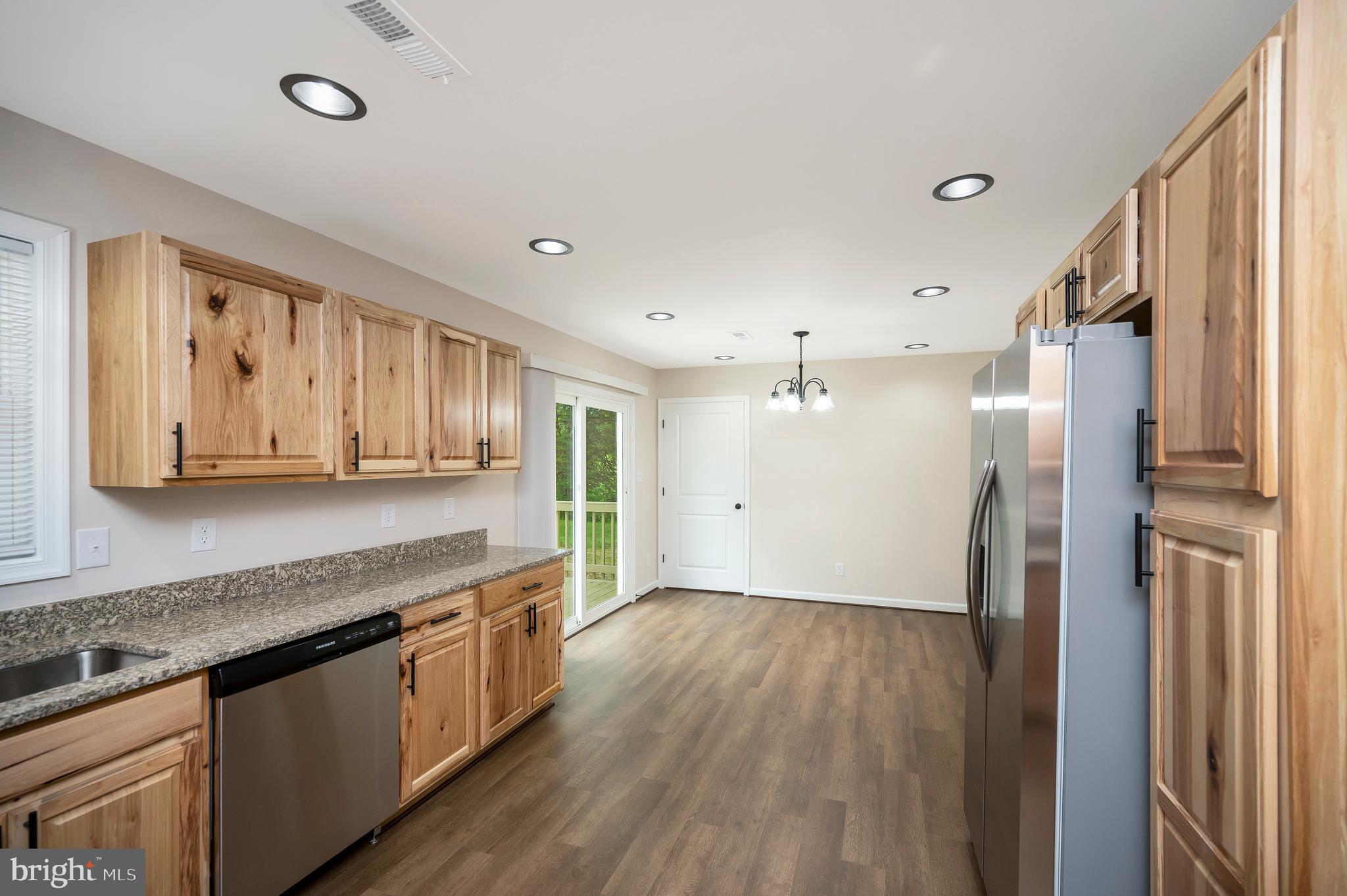 14169 Silver Hill Road Sumerduck, VA 22742 - Photo 9 of 40 a large kitchen with a lot of counter space and wooden floor