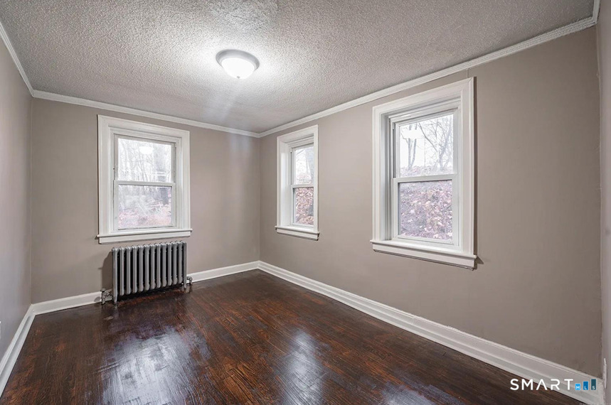 73 Silver Street Middletown, CT 06457 - Photo 16 of 30 a view of an empty room with wooden floor and a window