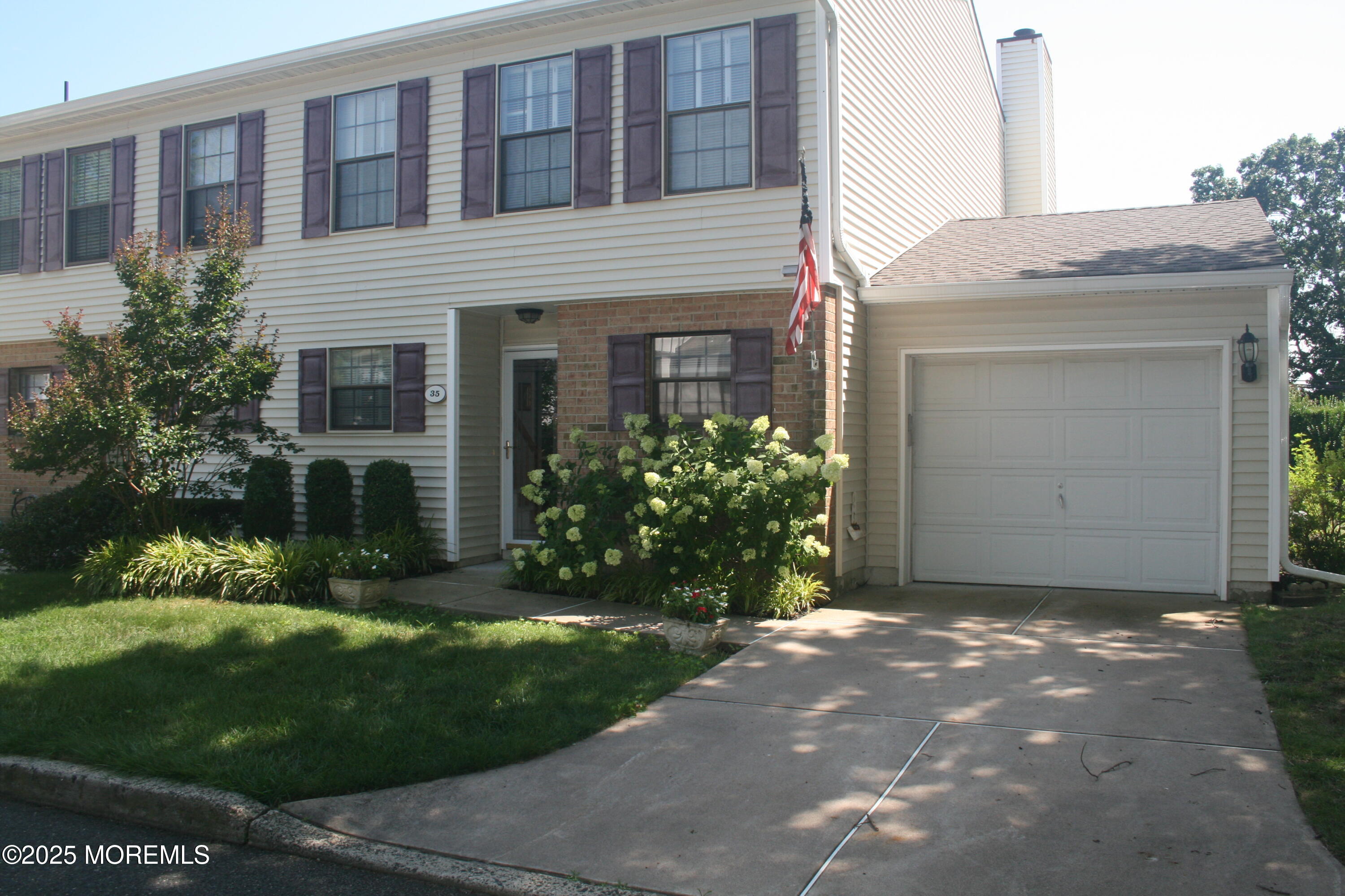 35 Apple Drive Spring Lake Heights, NJ 07762 - Photo 1 of 23 a view of a house with brick walls and a yard with plants