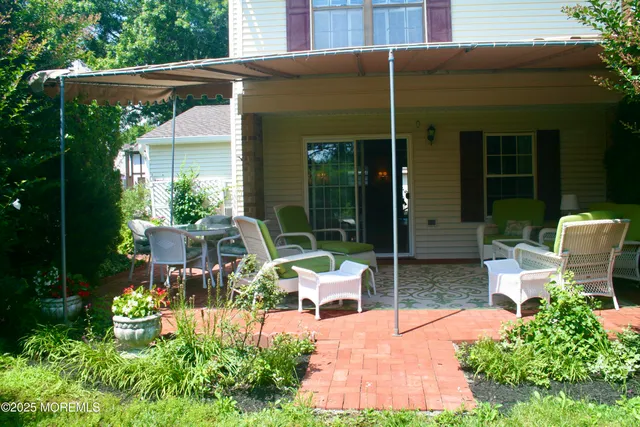 a view of a patio with table and chairs and potted plants