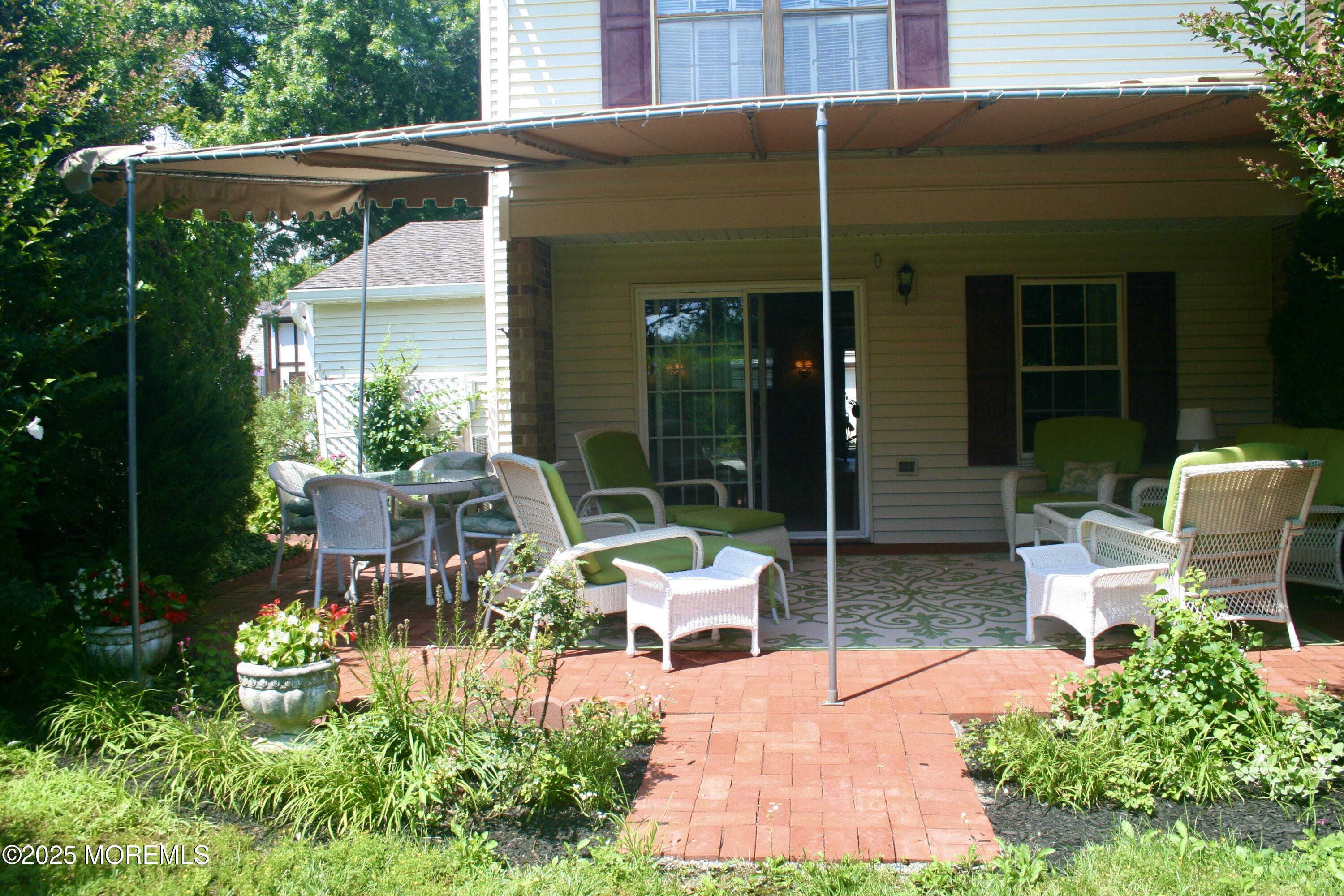 35 Apple Drive Spring Lake Heights, NJ 07762 - Photo 19 of 23 a view of a patio with table and chairs and potted plants