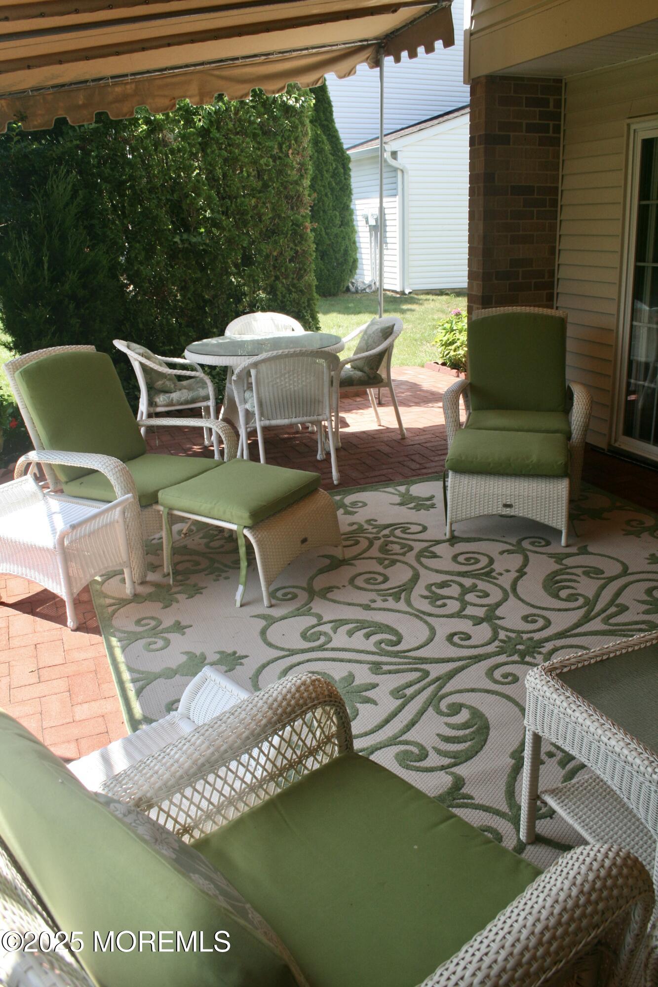35 Apple Drive Spring Lake Heights, NJ 07762 - Photo 20 of 23 a view of a patio with table and chairs with wooden floor and fence